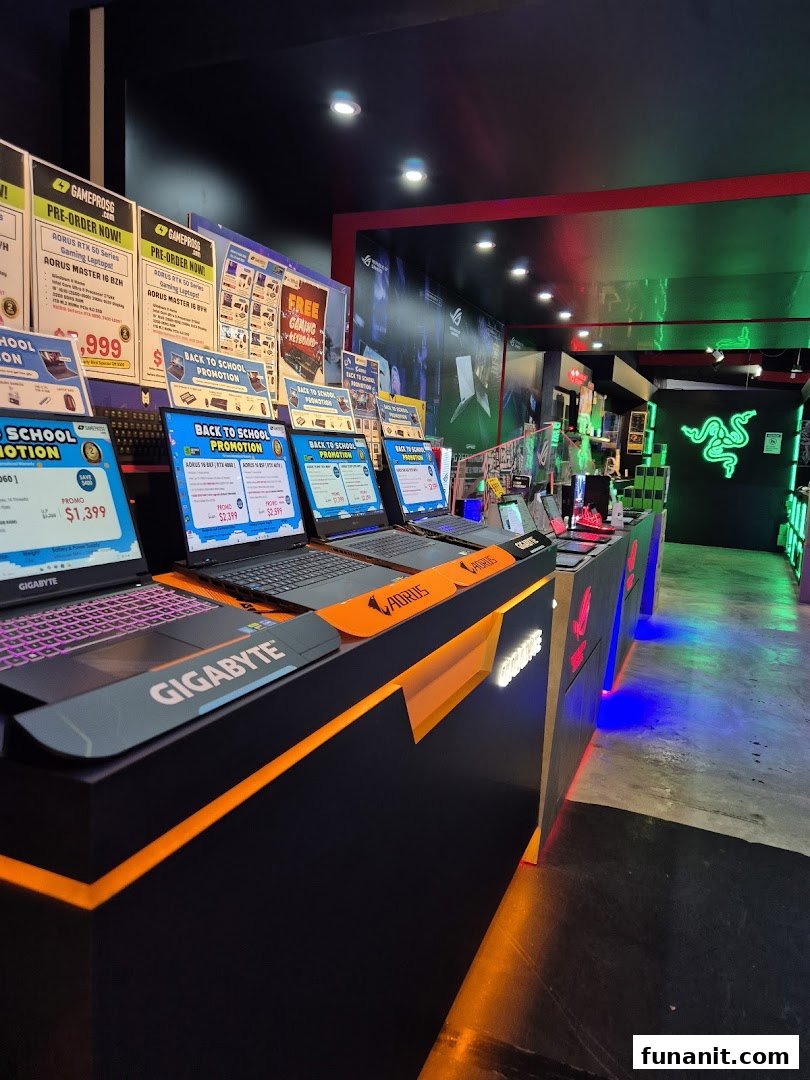 An interior view of GAMEPROSG, showcasing gaming laptops, accessories, and promotional displays.