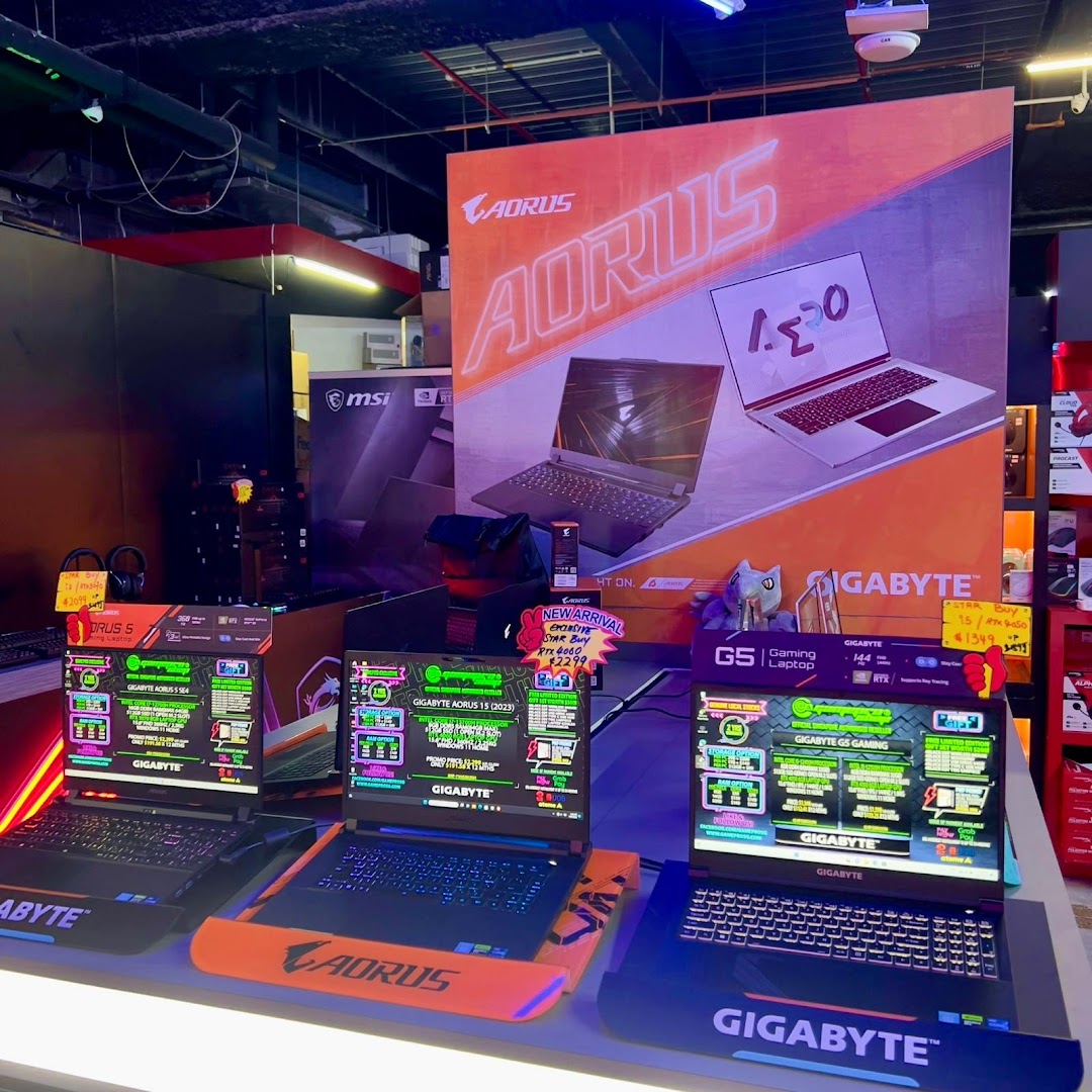 A vibrant display of high-performance gaming laptops from AORUS and Gigabyte in a tech retail store.