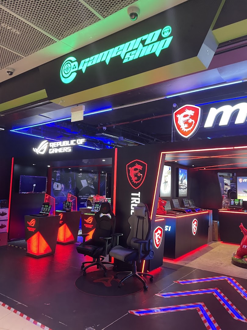 Interior of GAMEPROSG, a gaming shop, featuring gaming chairs, laptops, and prominent MSI and ROG branding.