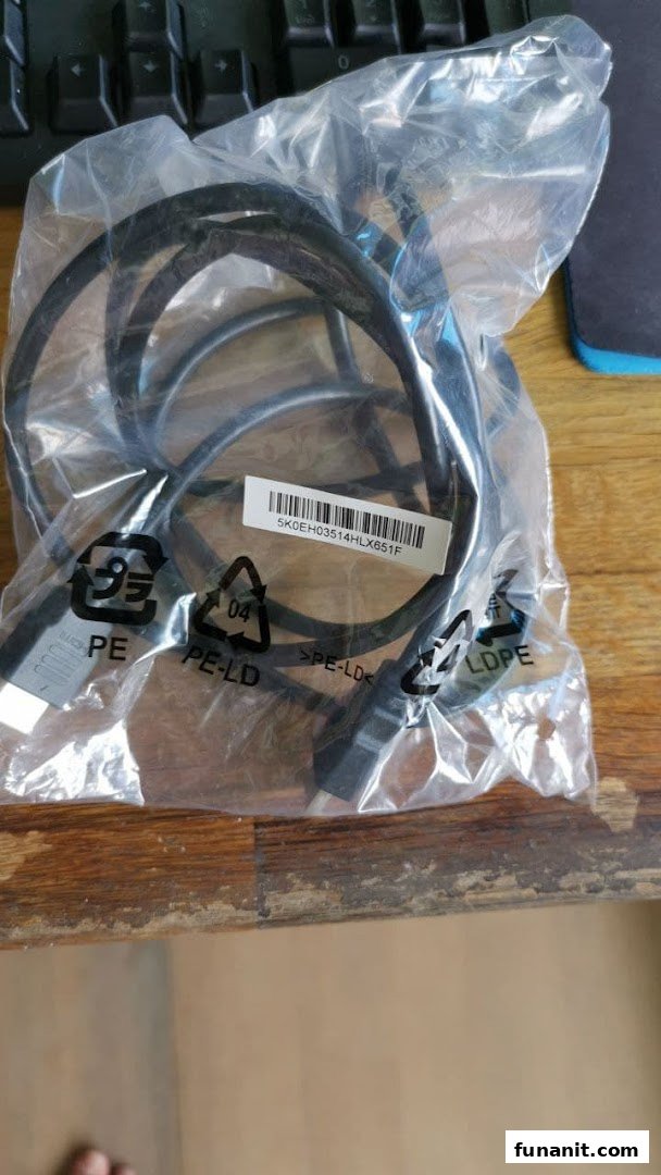 A black cable, likely for gaming or computer use, packaged in a clear plastic bag with a barcode.