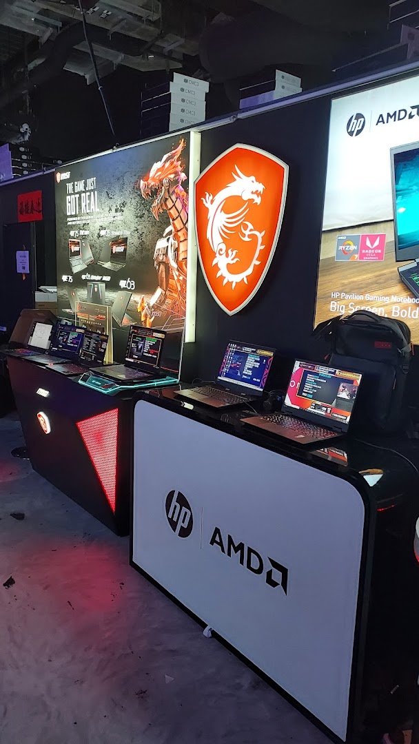 An interior shot of a tech retail space showcasing gaming laptops from MSI and HP/AMD on display.