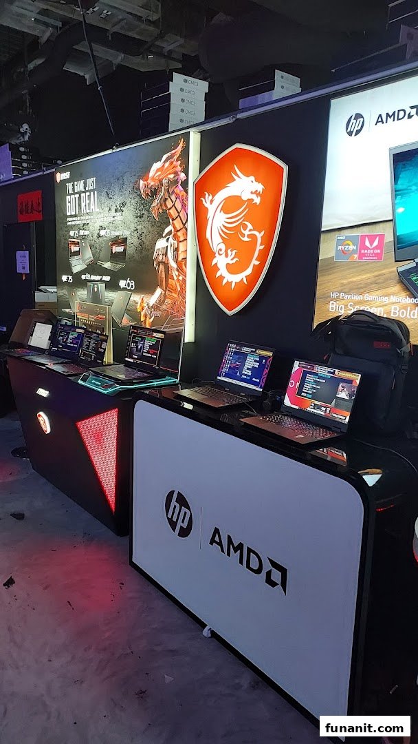 An interior shot of a tech retail space showcasing gaming laptops from MSI and HP/AMD on display.