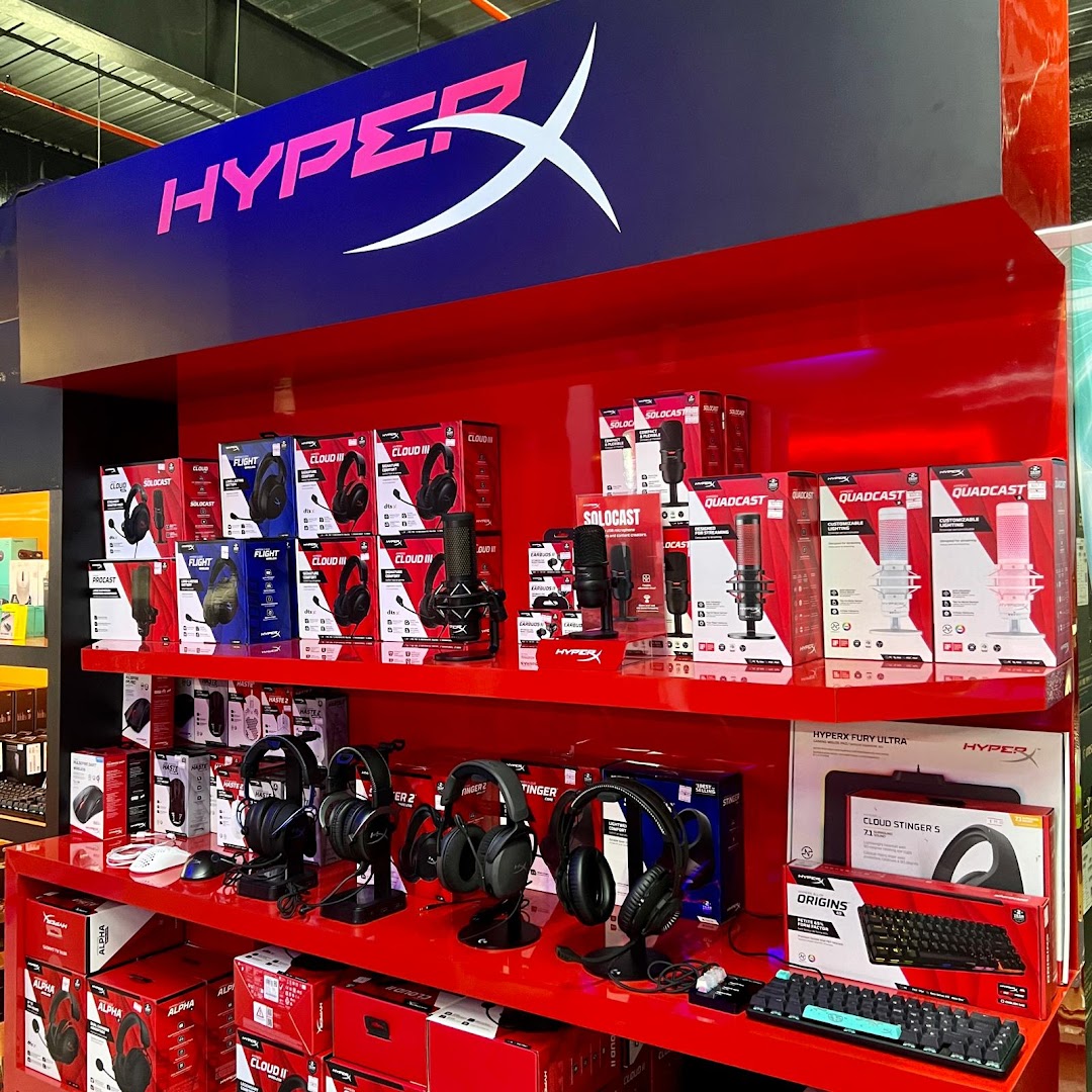 A vibrant red display showcasing HyperX gaming headsets, microphones, and keyboards.