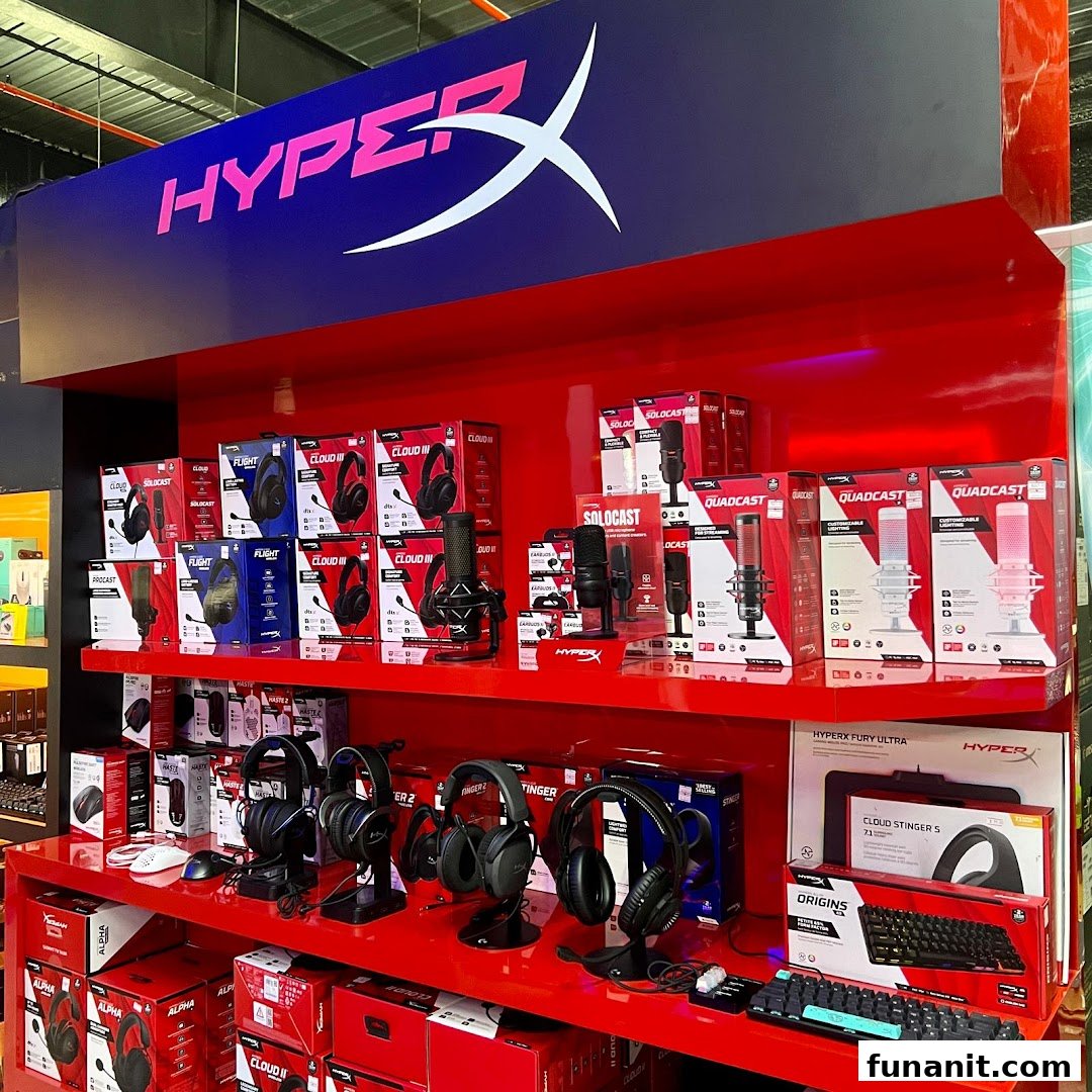 A vibrant red display showcasing HyperX gaming headsets, microphones, and keyboards.