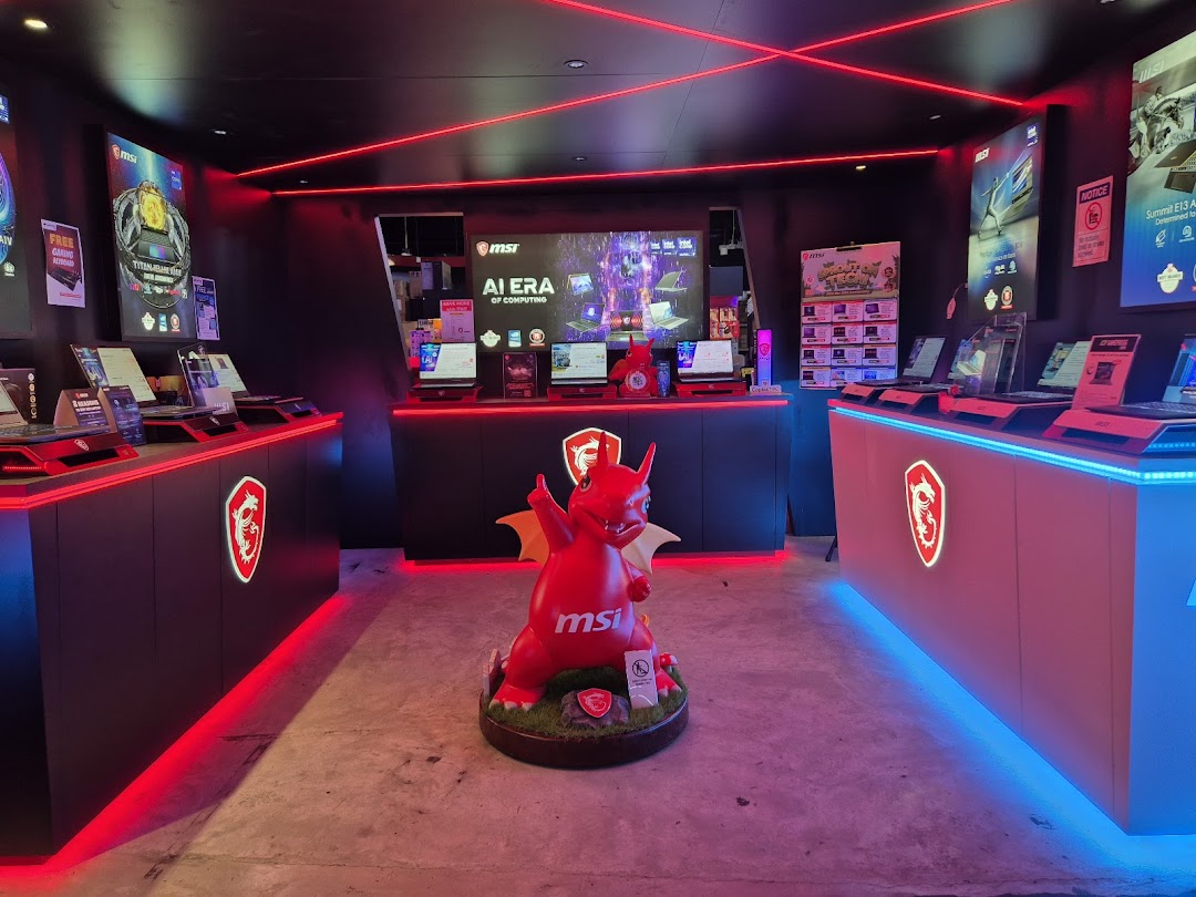 Interior of GAMEPROSG, a vibrant tech shop featuring MSI gaming laptops and a prominent dragon mascot.