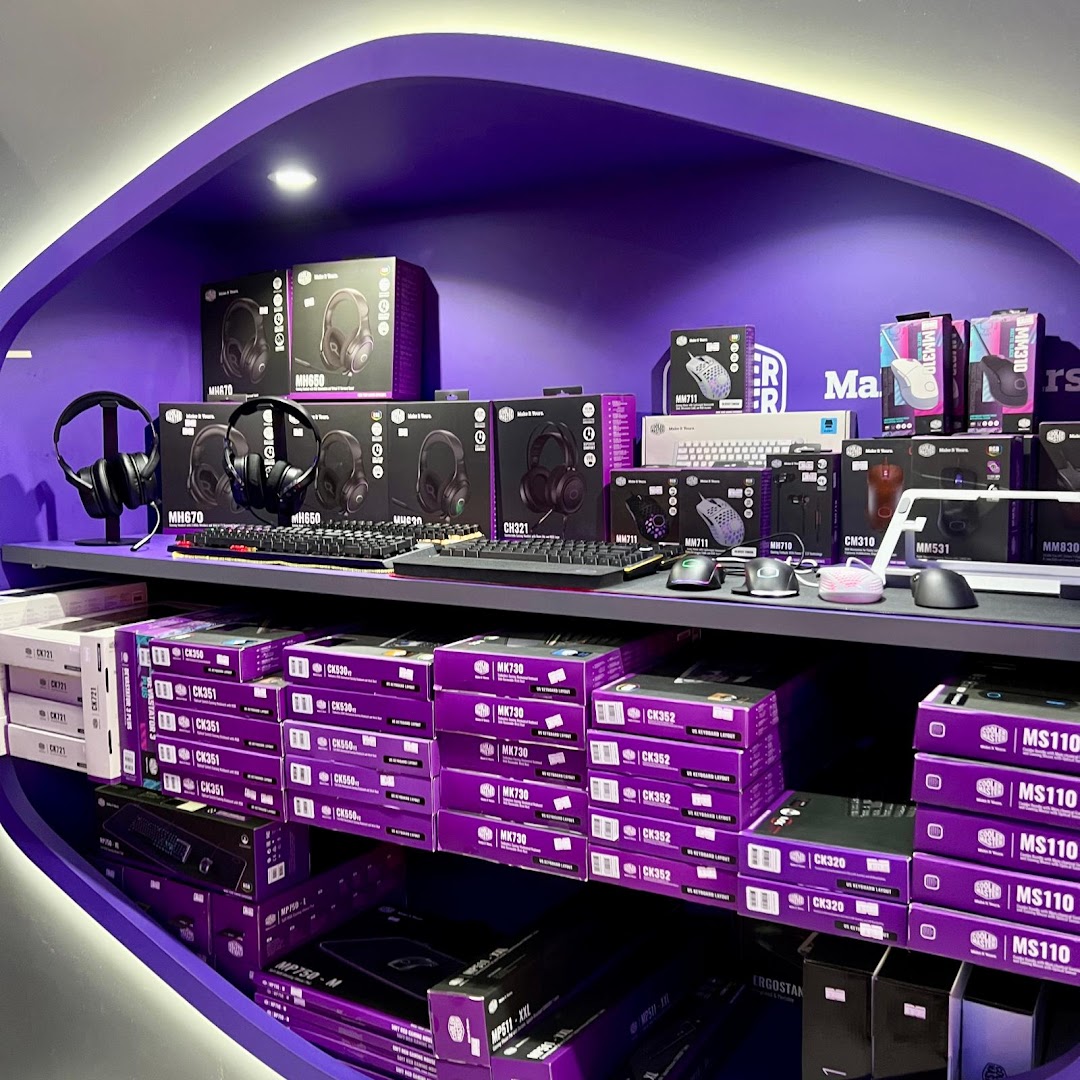 A vibrant purple display shelf showcasing a wide range of gaming peripherals like headphones, keyboards, and mice.
