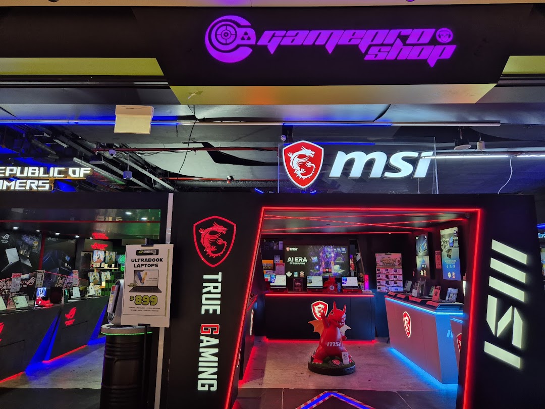 The vibrant entrance of GAMEPROSG, featuring MSI and Republic of Gamers branding and gaming laptops.