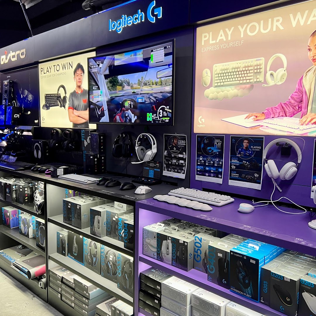 Interior view of a gaming peripherals store showcasing Logitech G products and interactive displays.