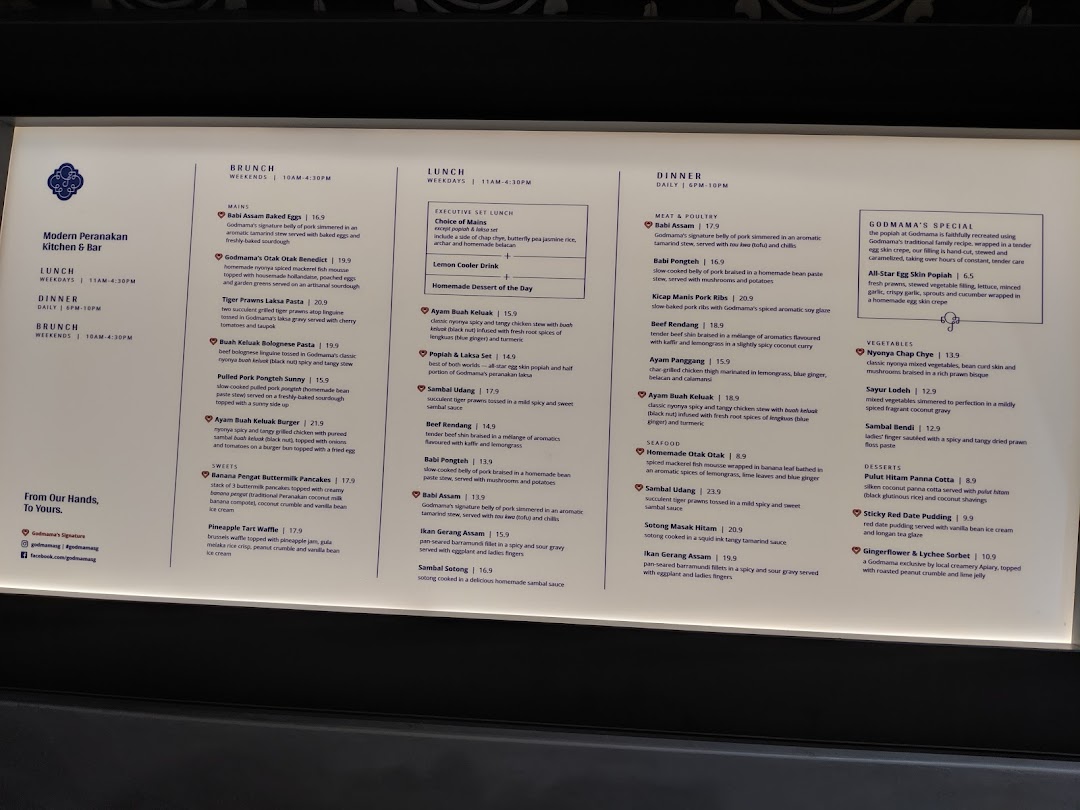 A detailed menu from Godmama, showcasing their Modern Peranakan cuisine for brunch, lunch, and dinner.