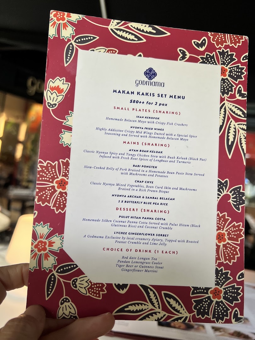 A detailed view of Godmama's Makan Kakis Set Menu, featuring Peranakan dishes and drinks.