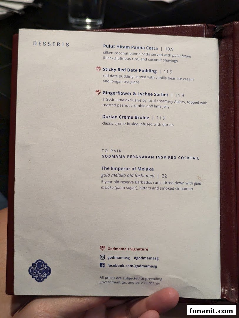 A close-up of Godmama's menu, featuring Peranakan-inspired desserts and a signature cocktail.
