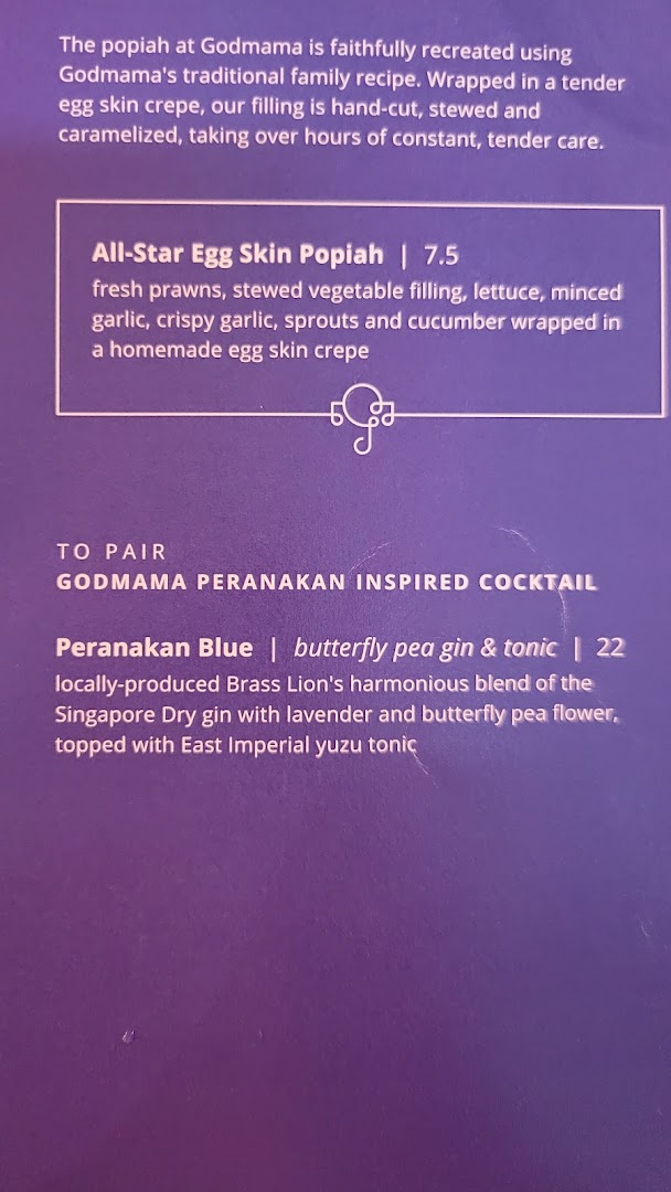 A close-up of Godmama's menu featuring their signature popiah and a Peranakan-inspired cocktail.