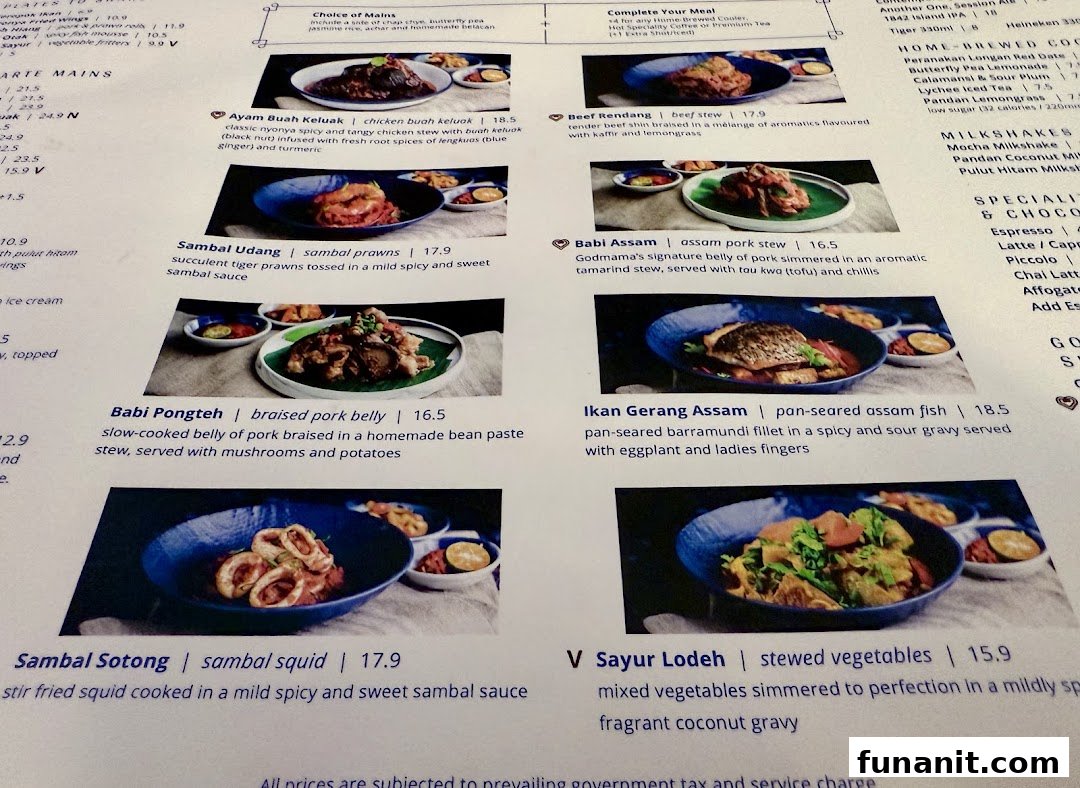 A detailed menu page from Godmama restaurant, showcasing various Peranakan main dishes with descriptions and prices.