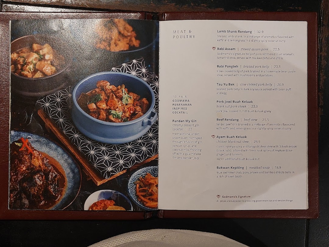 A detailed view of Godmama's menu, showcasing Peranakan meat, poultry, and cocktail dishes with descriptions and prices.