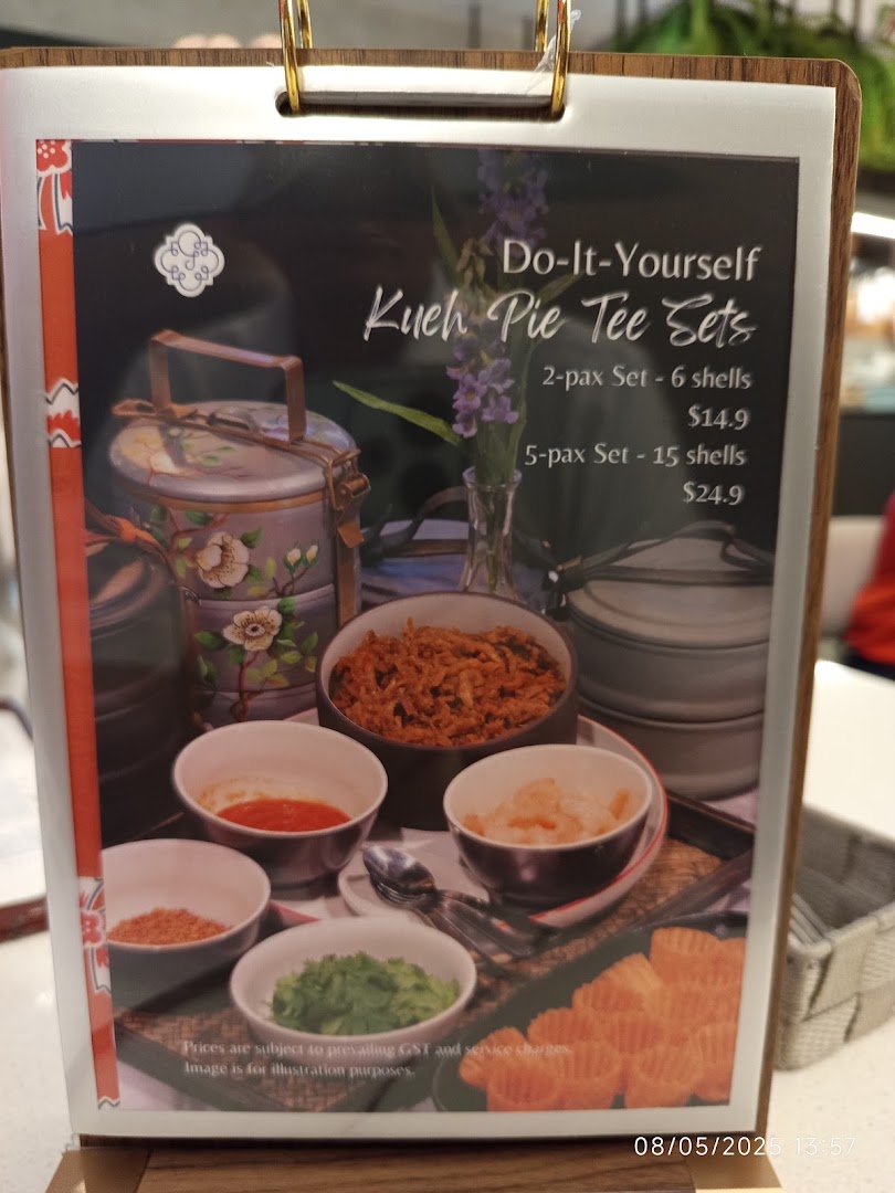 A menu board showcasing 'Do-It-Yourself Kueh Pie Tee Sets' with prices and an illustrative image.