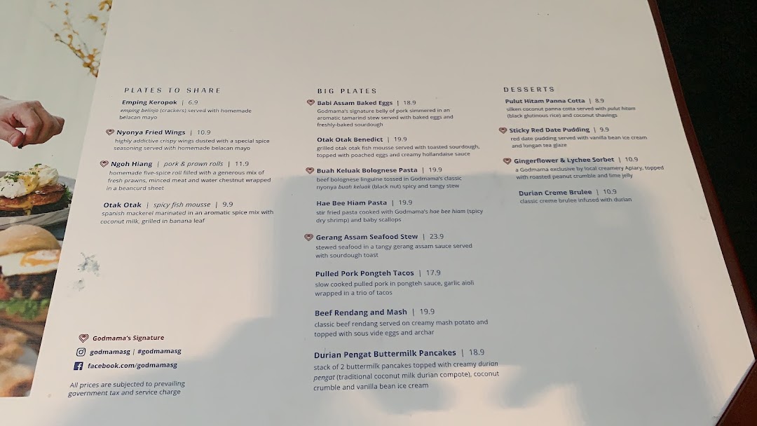 A detailed menu from Godmama restaurant, showcasing a variety of Peranakan-inspired dishes and desserts.