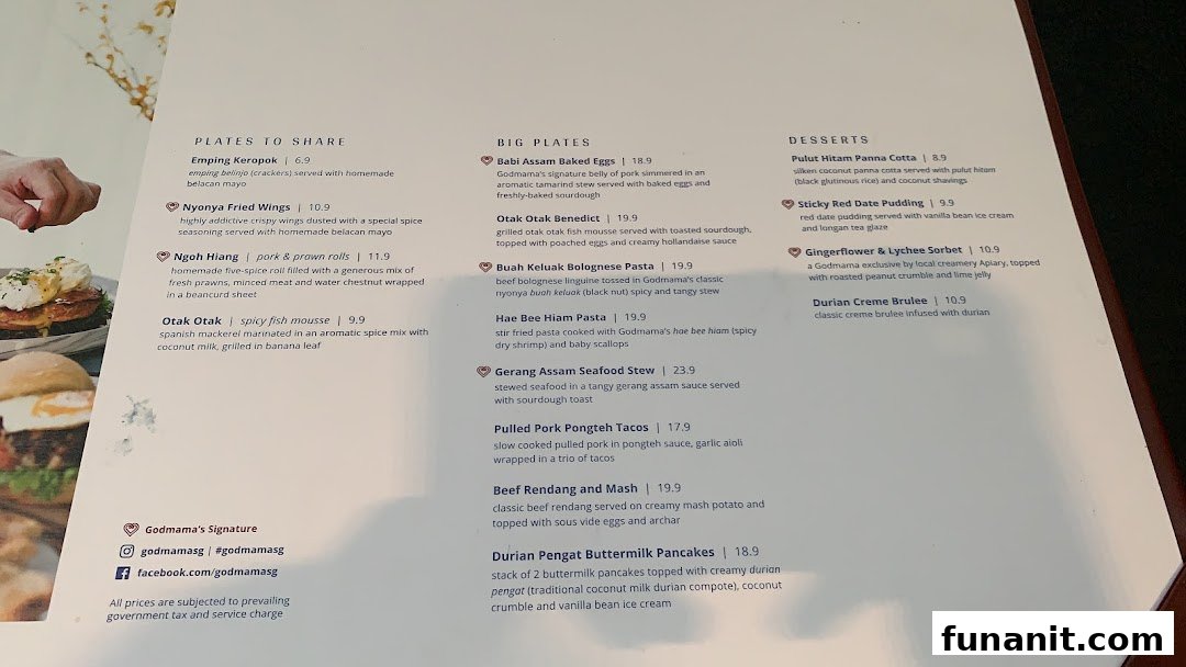 A detailed menu from Godmama restaurant, showcasing a variety of Peranakan-inspired dishes and desserts.