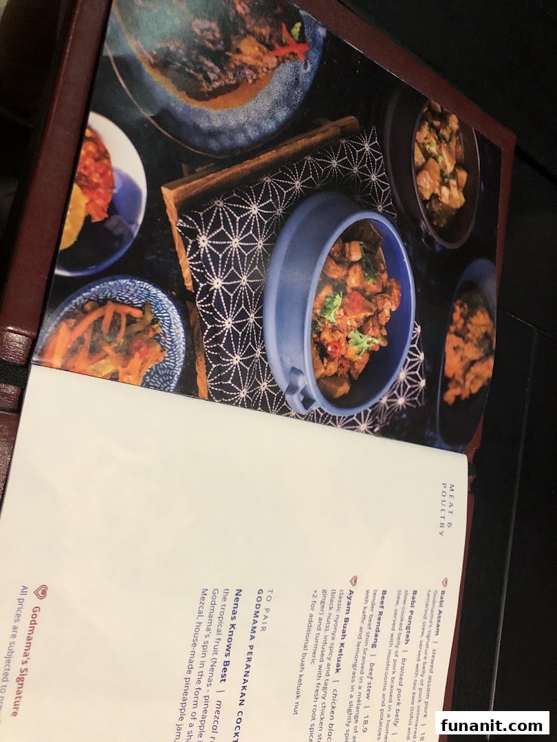 A vibrant menu page from Godmama restaurant, showcasing Peranakan dishes and cocktails with enticing food photography.