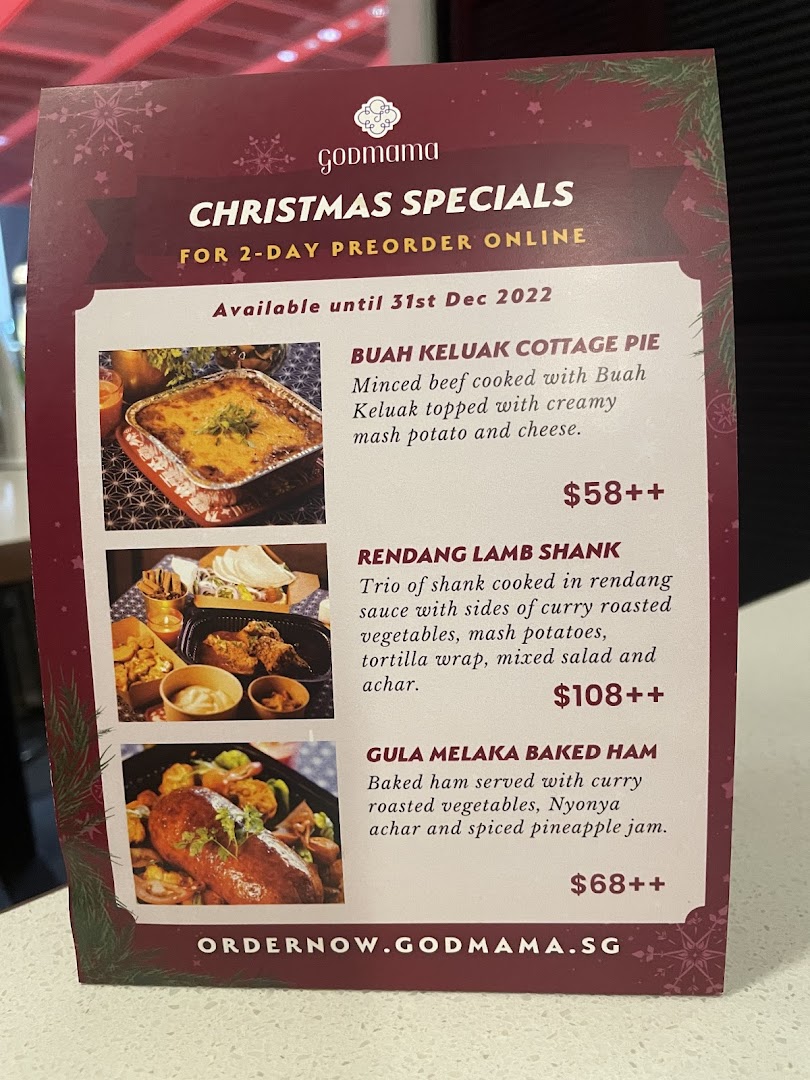 A menu stand showcasing Godmama's Christmas Specials for online preorder.