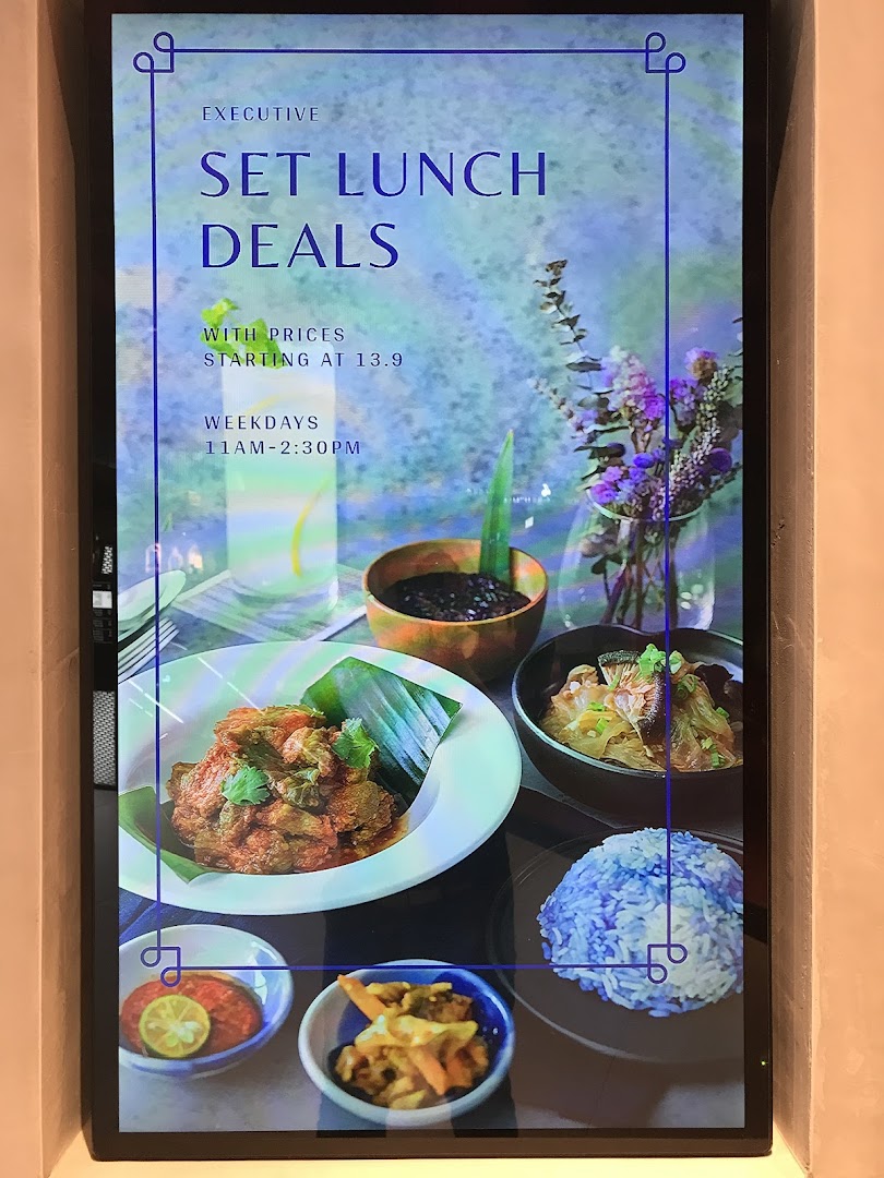 A digital display showcasing Godmama's Executive Set Lunch Deals with vibrant Peranakan dishes.
