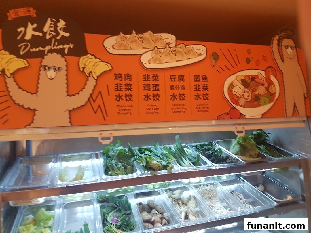 A vibrant display of fresh ingredients and a menu board showcasing various dumpling options and a mala tang bowl.