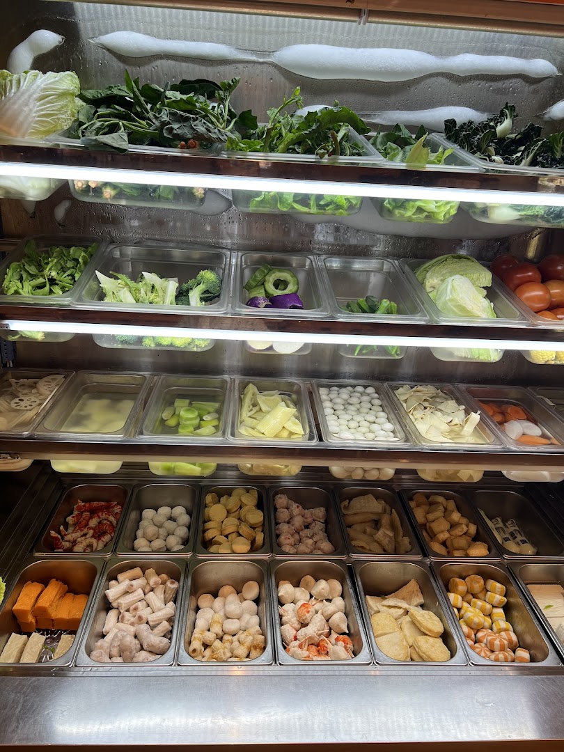 A refrigerated display showcasing a wide variety of fresh vegetables, meats, and other ingredients for a customizable meal.