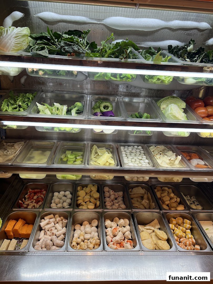 A refrigerated display showcasing a wide variety of fresh vegetables, meats, and other ingredients for a customizable meal.