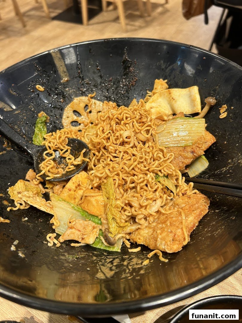 A close-up of a delicious bowl of Mala Tang with instant noodles, vegetables, and other ingredients.