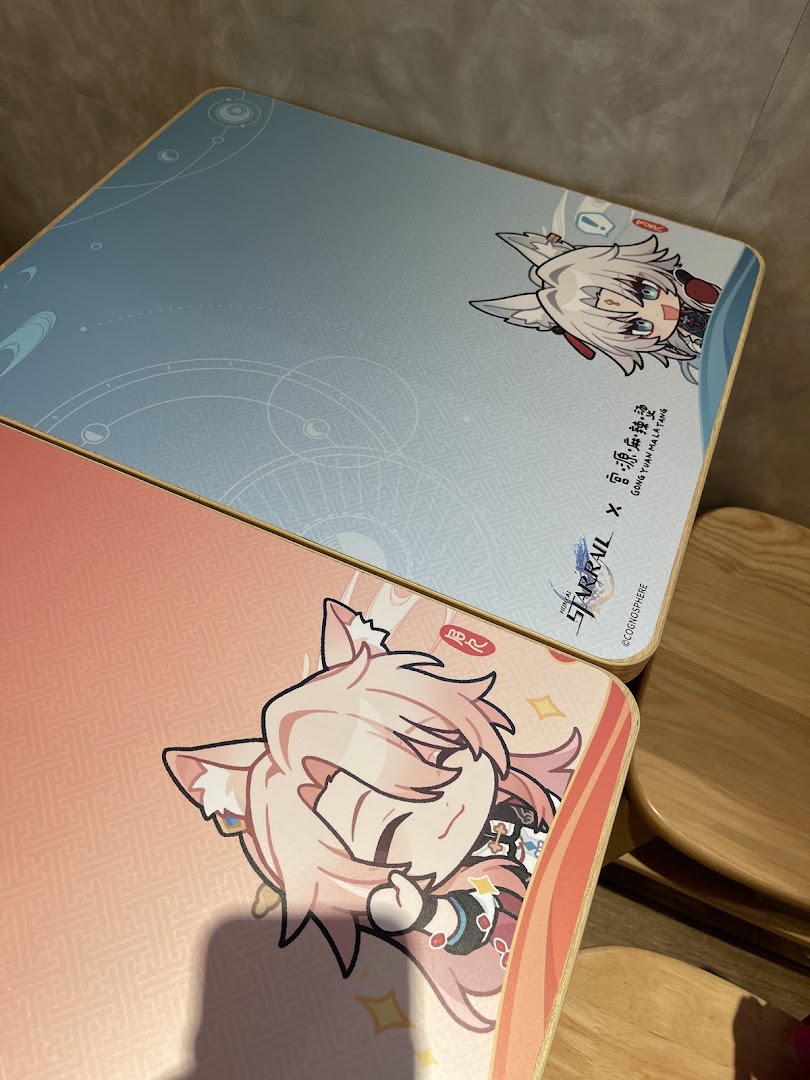Two tabletops featuring anime character designs, likely from a Honkai: Star Rail collaboration, inside Gong Yuan Ma La Tang.