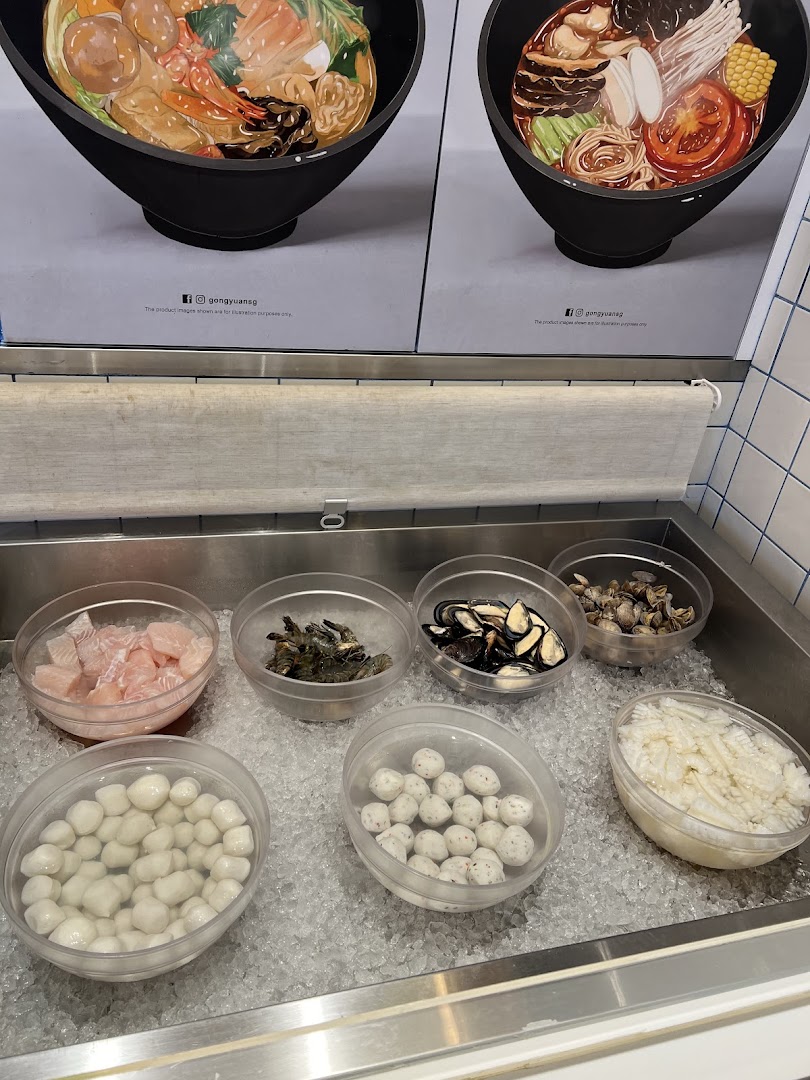 A vibrant display of fresh ingredients like seafood, fish balls, and vegetables on ice for Mala Tang.
