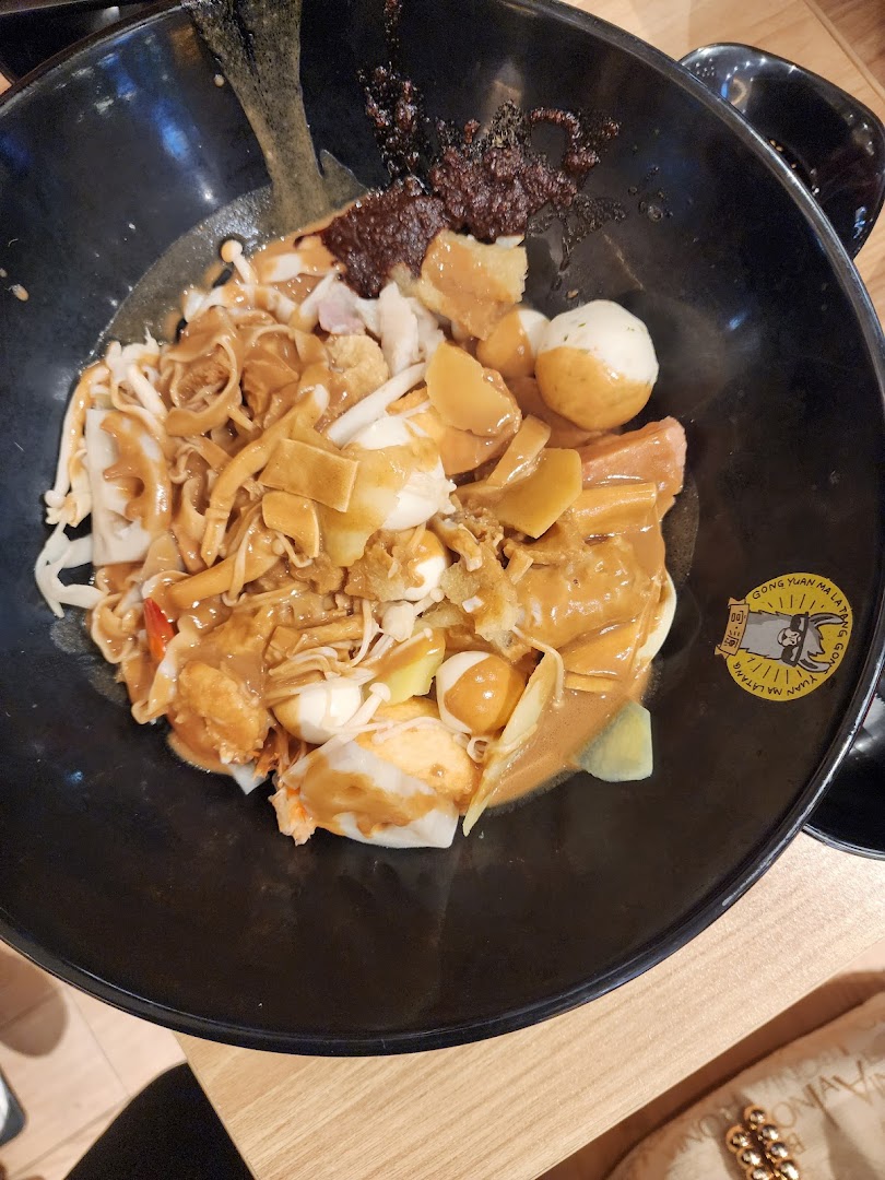 A close-up of a delicious bowl of Mala Tang with various ingredients and rich sauce.