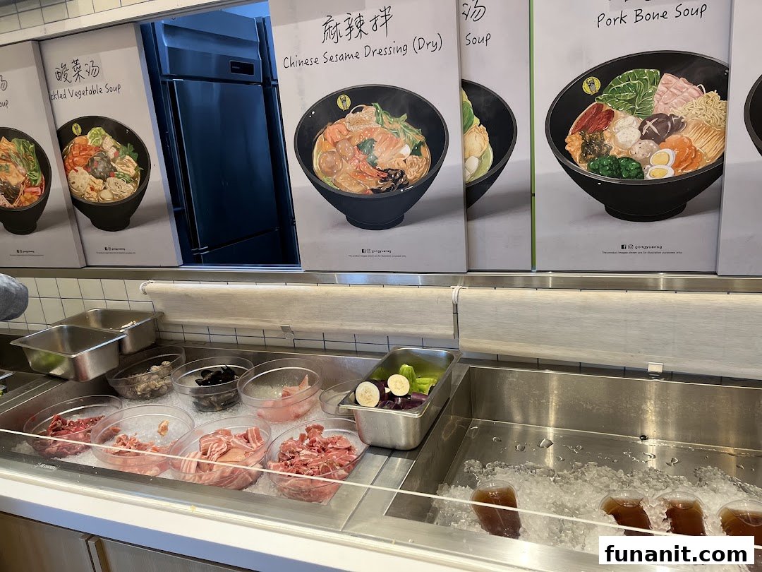 A self-service counter displaying fresh ingredients for customizable hotpot, with illustrative dish posters above.