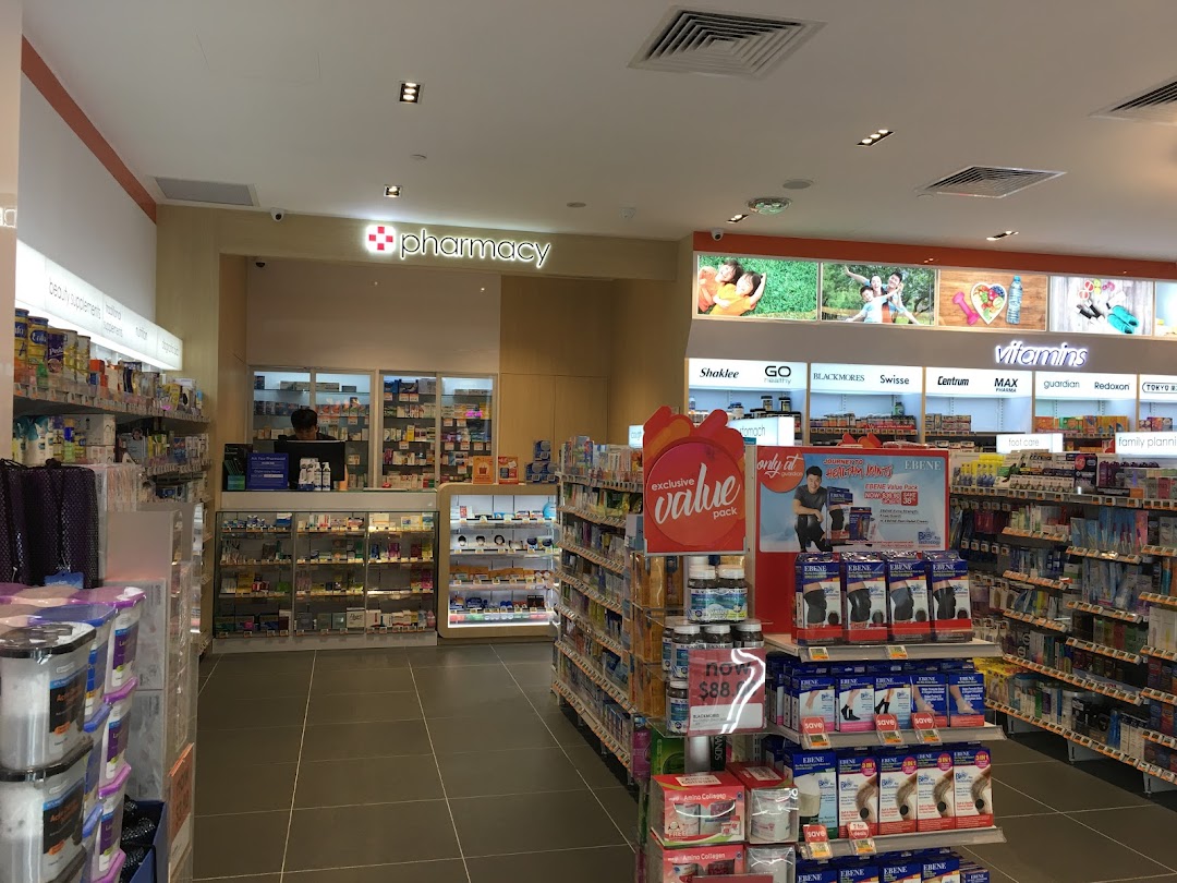 Interior view of Guardian Health & Beauty, showcasing health products, vitamins, and the pharmacy counter.