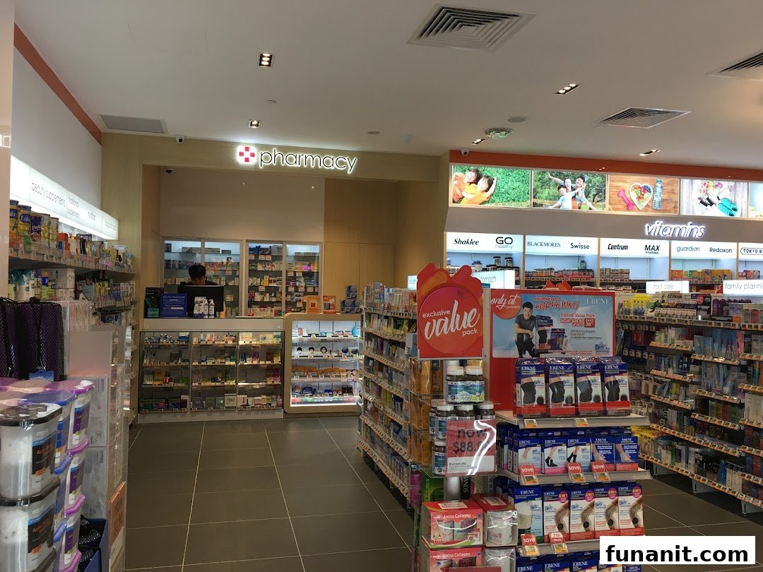 Interior view of Guardian Health & Beauty, showcasing health products, vitamins, and the pharmacy counter.