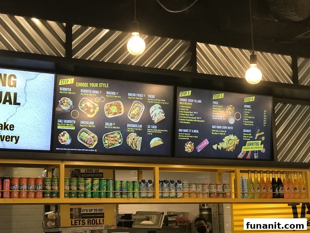 A digital menu board displaying various Mexican food options and prices at Guzman y Gomez.