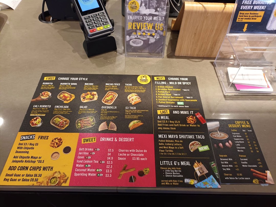 A detailed menu display at Guzman y Gomez, showcasing food, drinks, and dessert options.