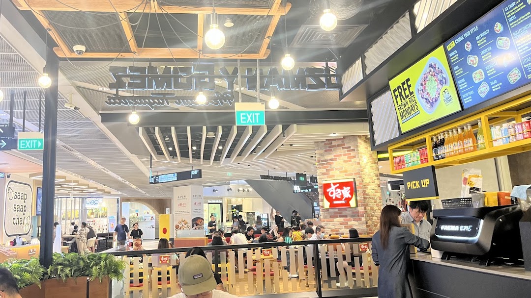 A vibrant interior shot of Guzman y Gomez, showcasing its menu board and dining area.
