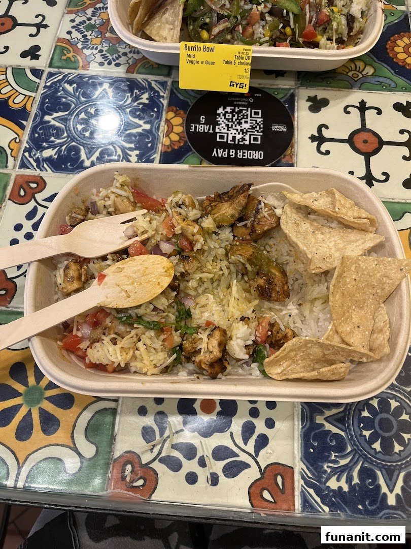 Two delicious Guzman y Gomez burrito bowls with fresh ingredients on a vibrant tiled table.