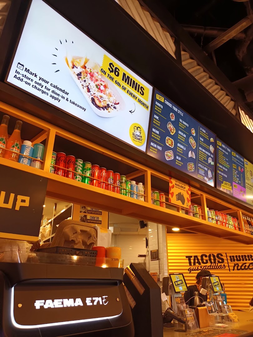 Interior shot of Guzman y Gomez featuring a digital menu board and counter area.