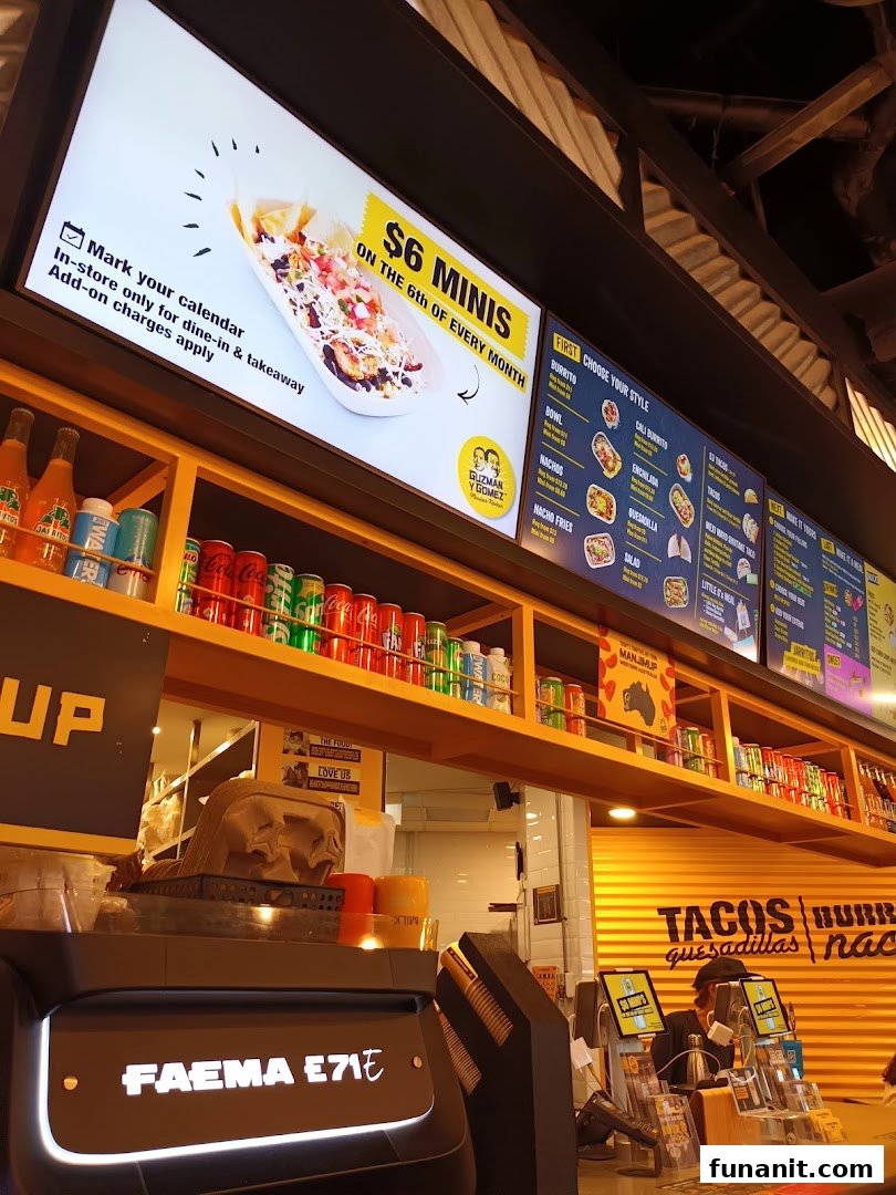 Interior shot of Guzman y Gomez featuring a digital menu board and counter area.