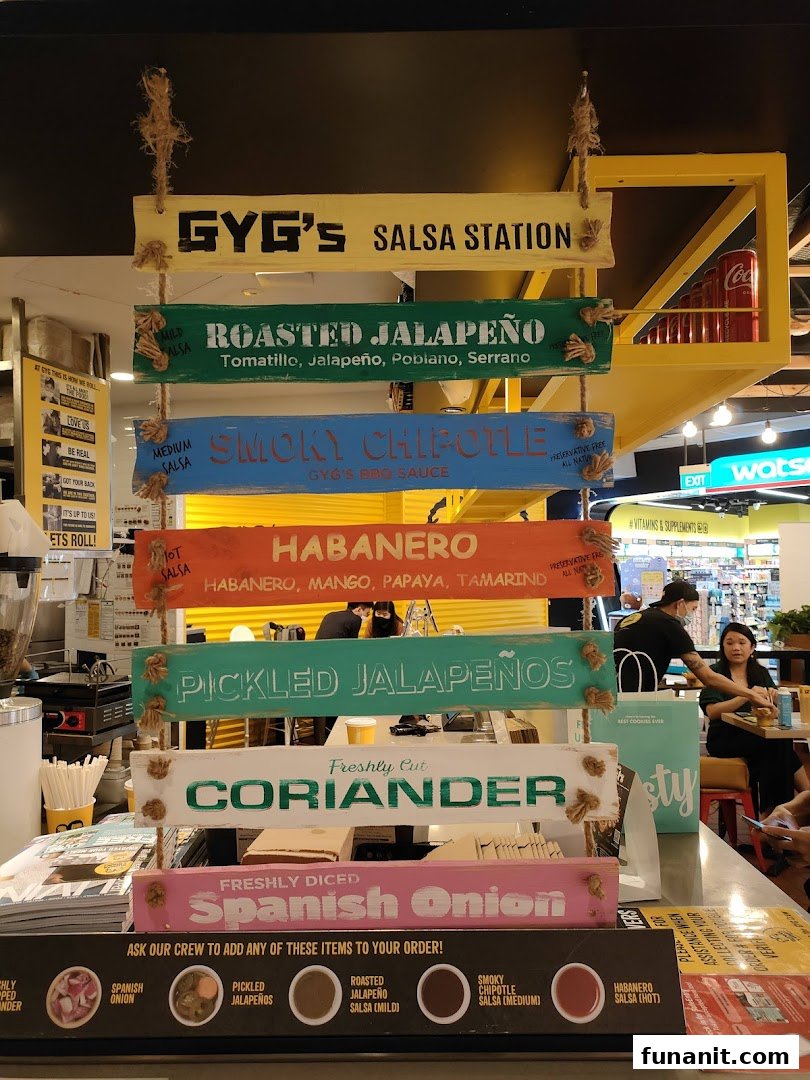 A vibrant display showcasing Guzman y Gomez's fresh salsa and topping station with various options.