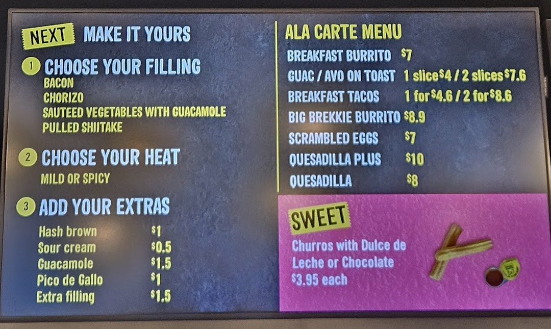 A digital menu board displaying breakfast items, customizable options, and sweet treats.