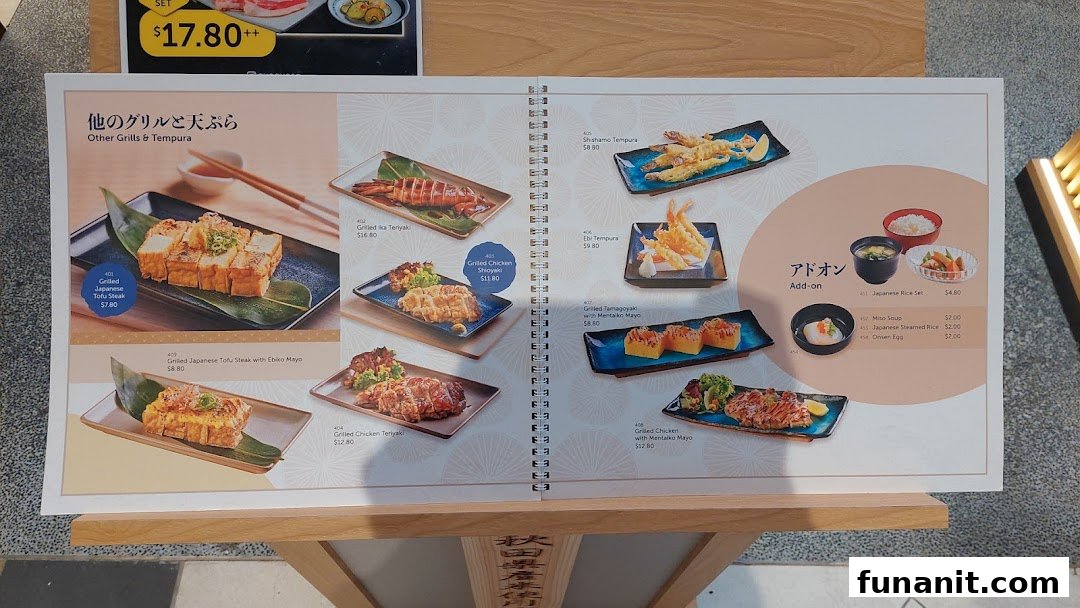A menu page displaying various Japanese grilled items, tempura, and add-ons with prices.