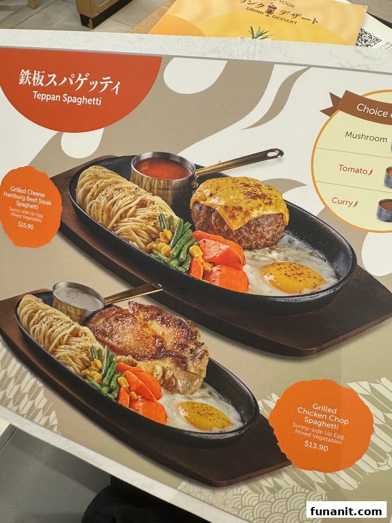 Two sizzling Teppan Spaghetti dishes with steak and chicken, served on hot plates.