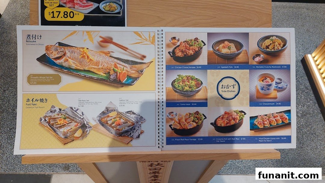 A display menu showcasing various Japanese grilled fish sets, foil-baked dishes, and side dishes.