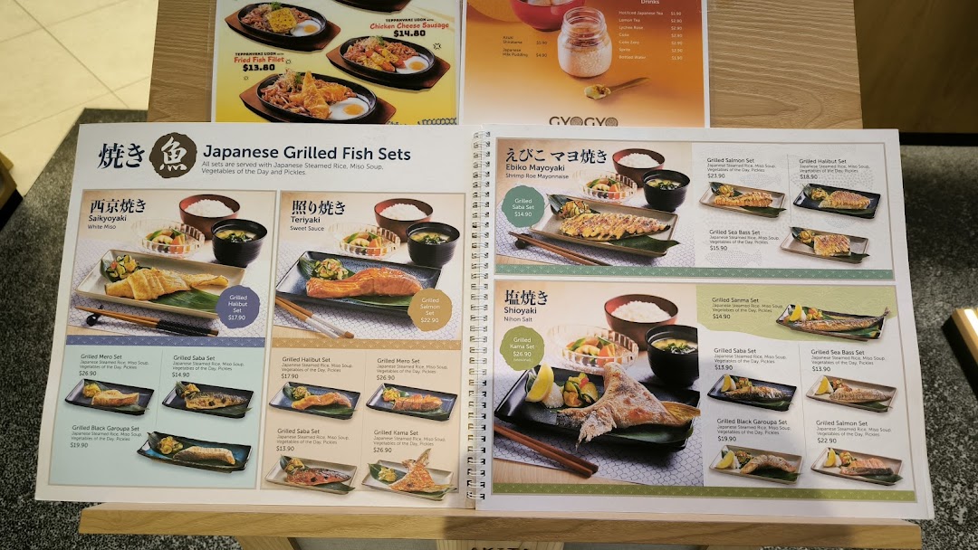 An open menu displaying various Japanese grilled fish sets with descriptions and prices.