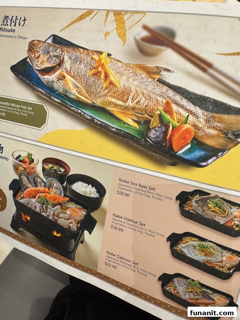 A close-up of a menu displaying various Japanese grilled fish and sukiyaki hot pot sets.