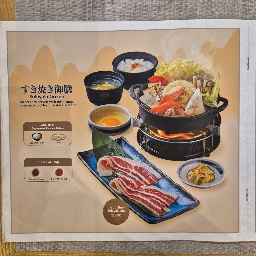A vibrant Sukiyaki Gozen set featuring beef, vegetables, and customizable options from GyoGyo.