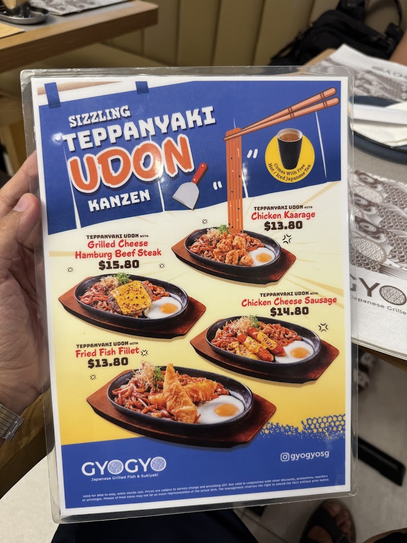 A menu displaying various sizzling teppanyaki udon dishes with different toppings and prices.