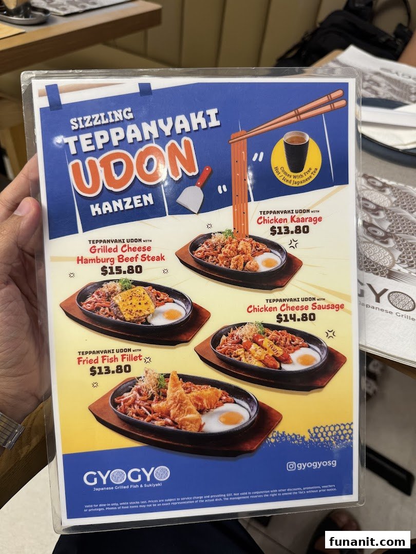 A menu displaying various sizzling teppanyaki udon dishes with different toppings and prices.